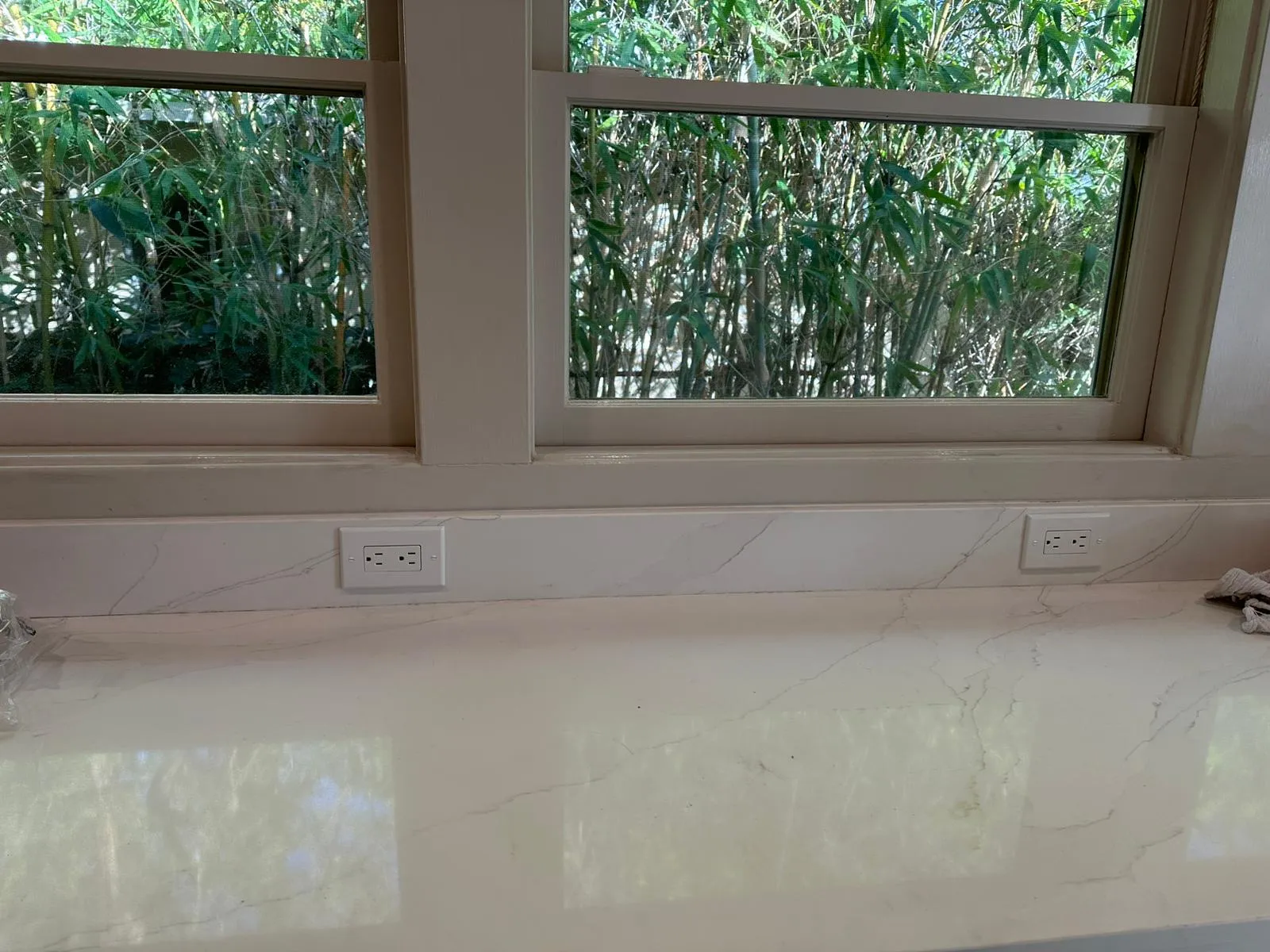 Outlets flush-mounted in marble window sill. Installation detail by Martinez Electric Corp