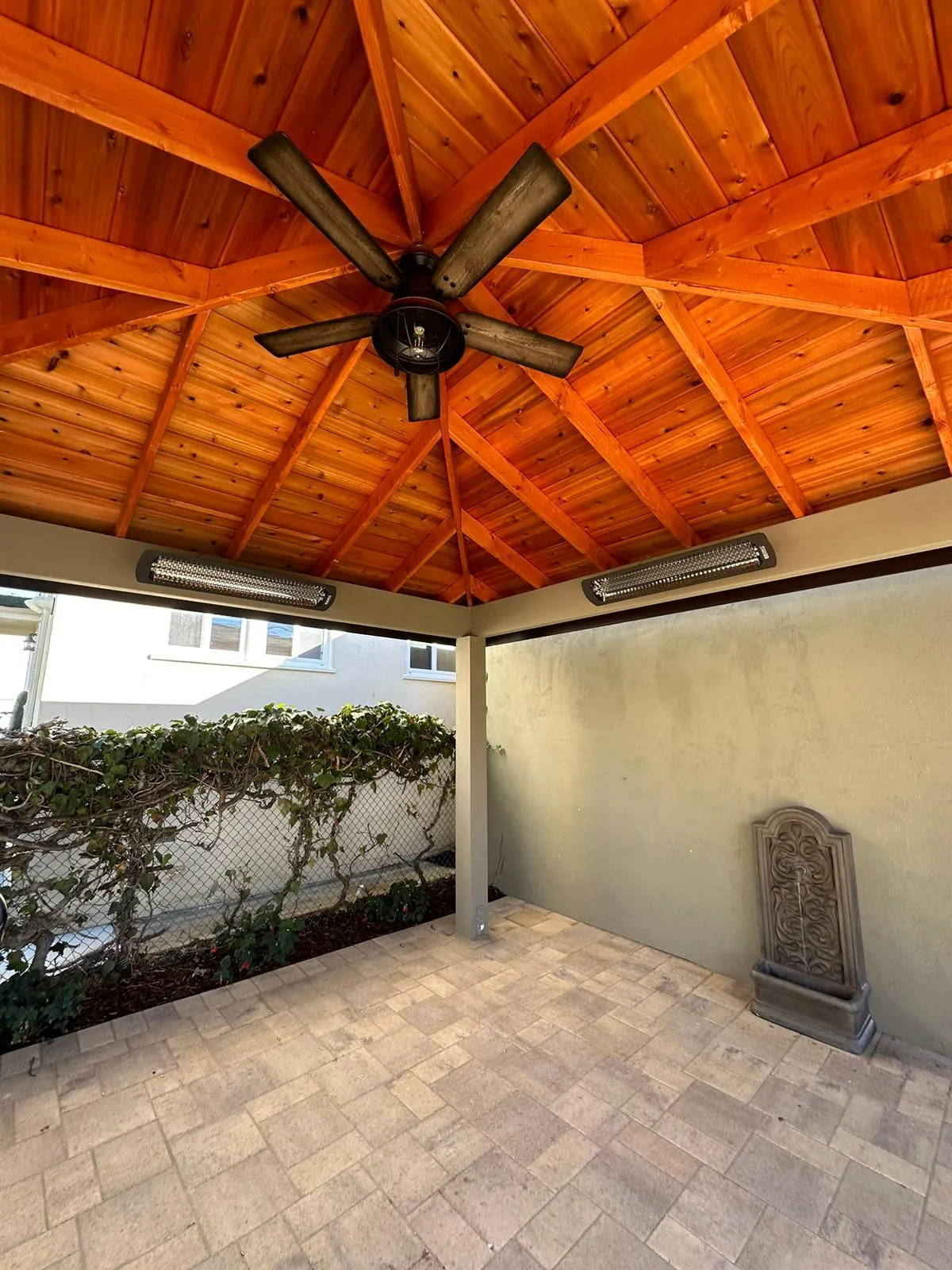 Outdoor patio with cedar wood ceiling, ceiling fan and infrared heaters. Martinez Electric Corp