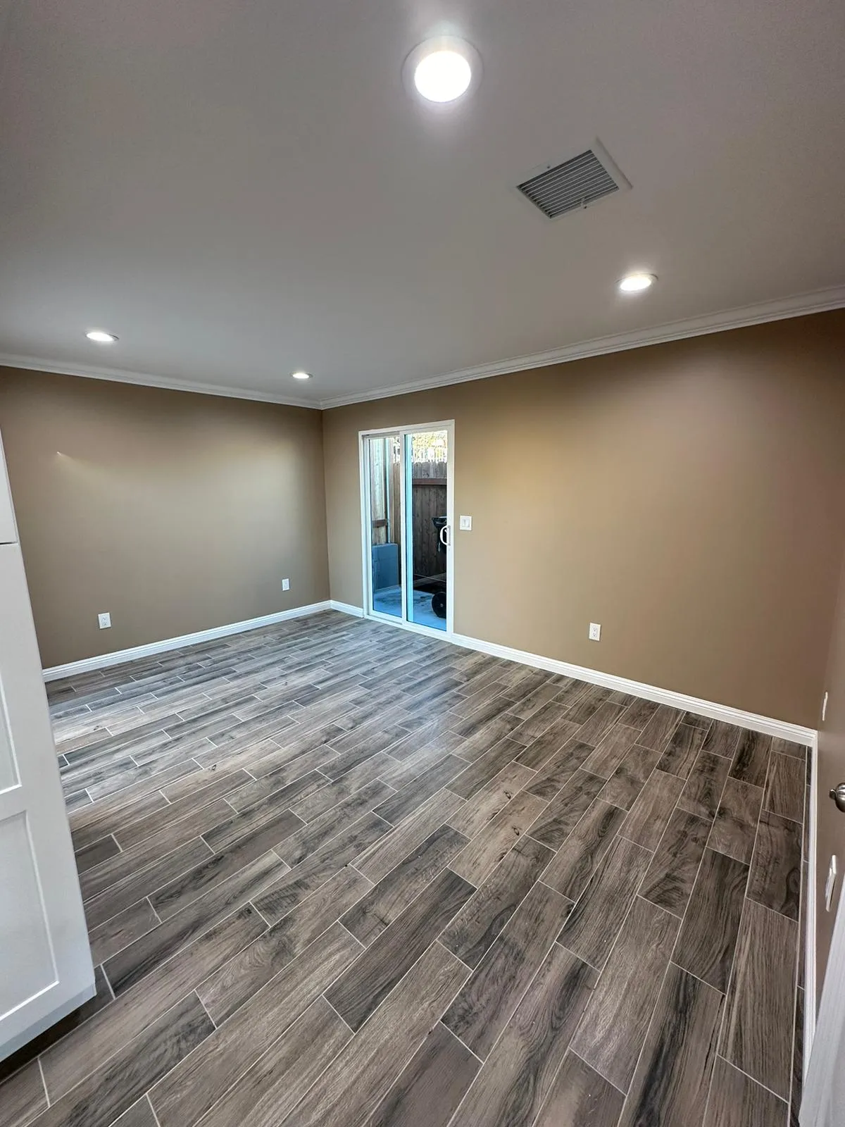 Bedroom with recessed lighting and sliding door to patio. Martinez Electric Corp