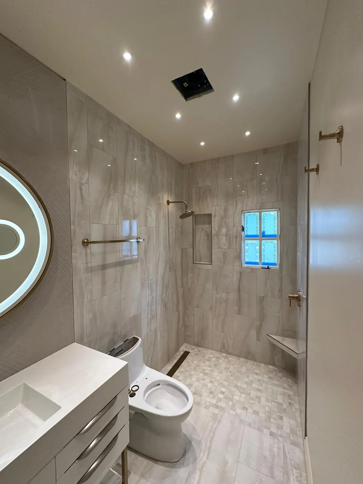 Master bath with walk-in shower, brass fixtures and recessed lighting. Martinez Electric Corp