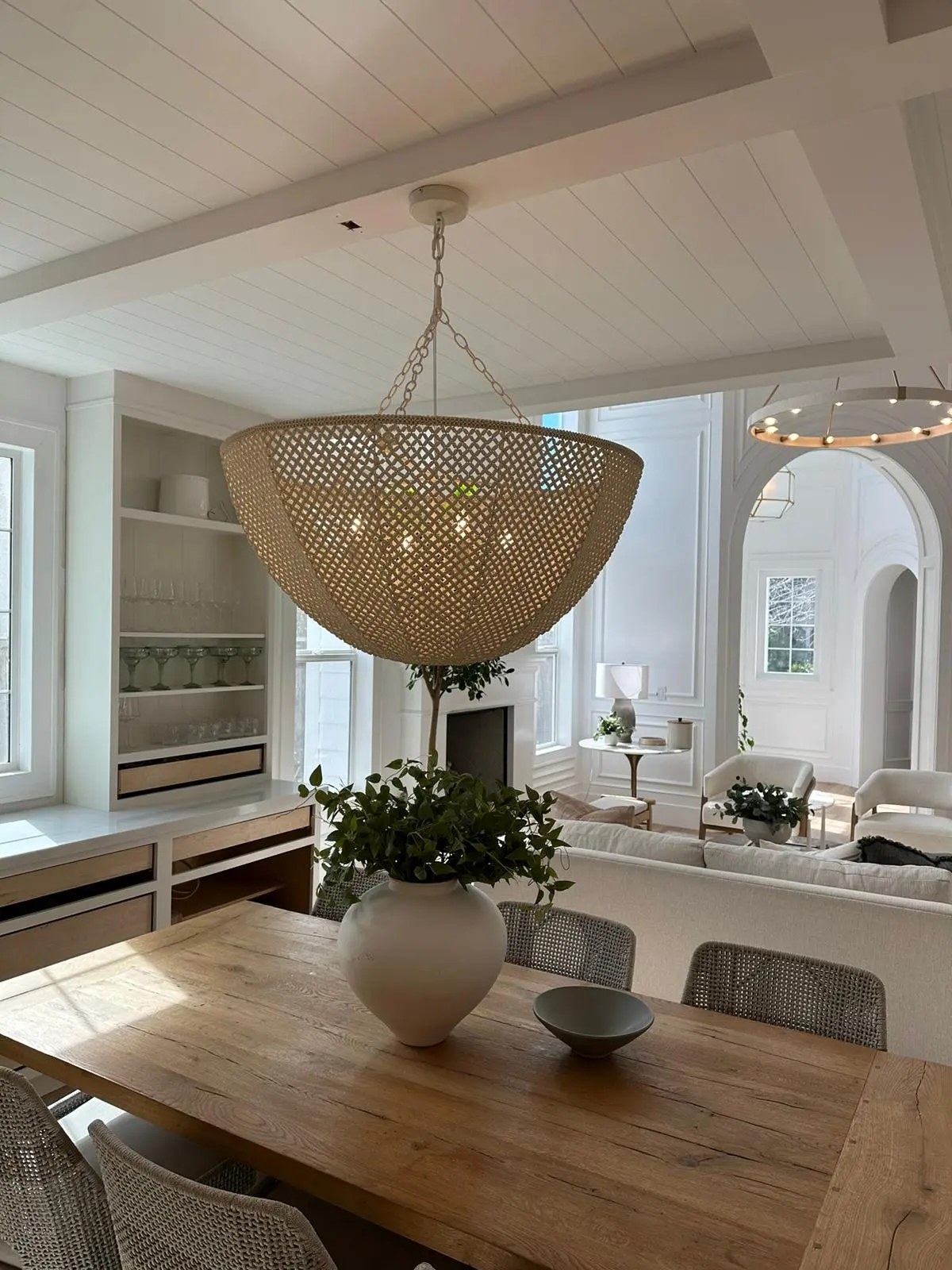 Bright dining room with rattan dome chandelier and coffered ceiling. Ambient lighting by Martinez Electric Corp
