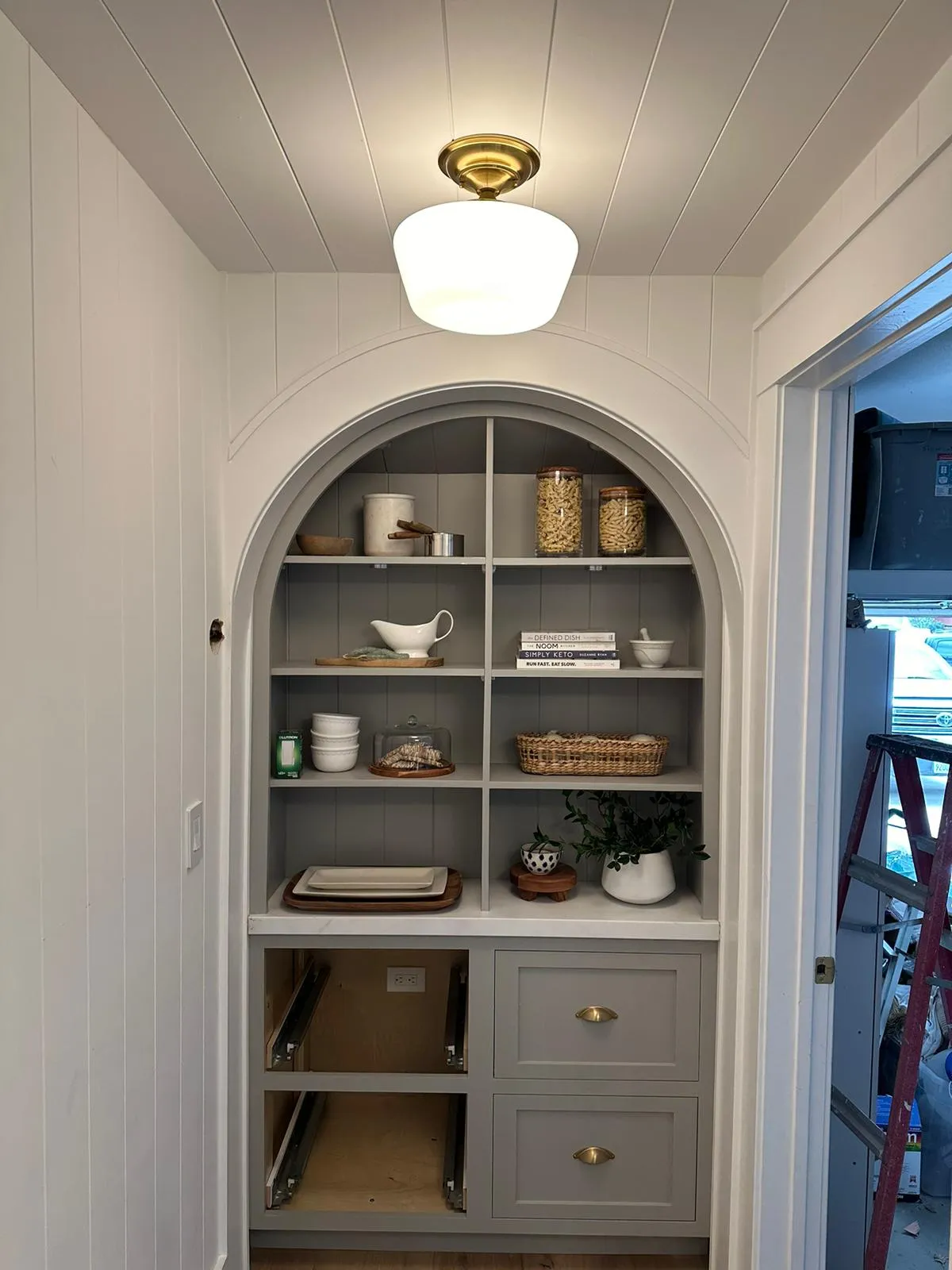 Arched built-in pantry with brass dome ceiling fixture. Martinez Electric Corp