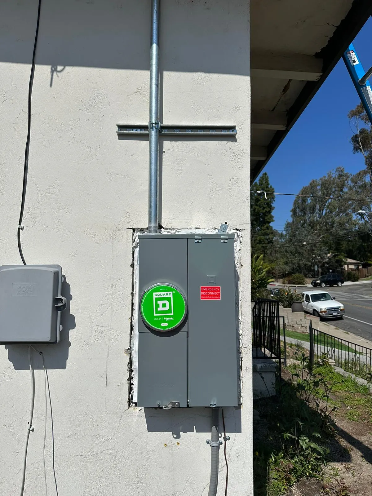 Square D main service with emergency disconnect on stucco wall. Martinez Electric Corp
