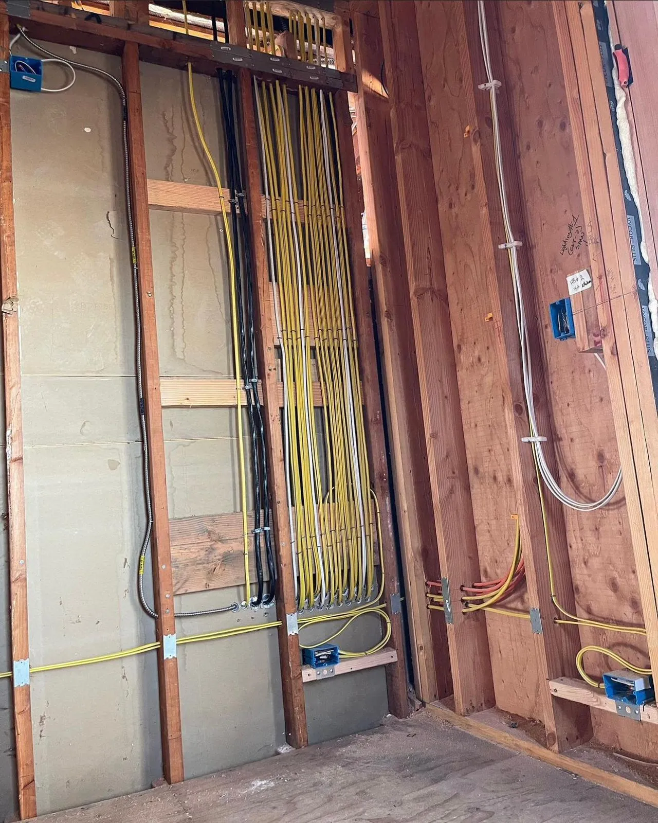Structured wiring through framed walls during whole-home rewire. Martinez Electric Corp