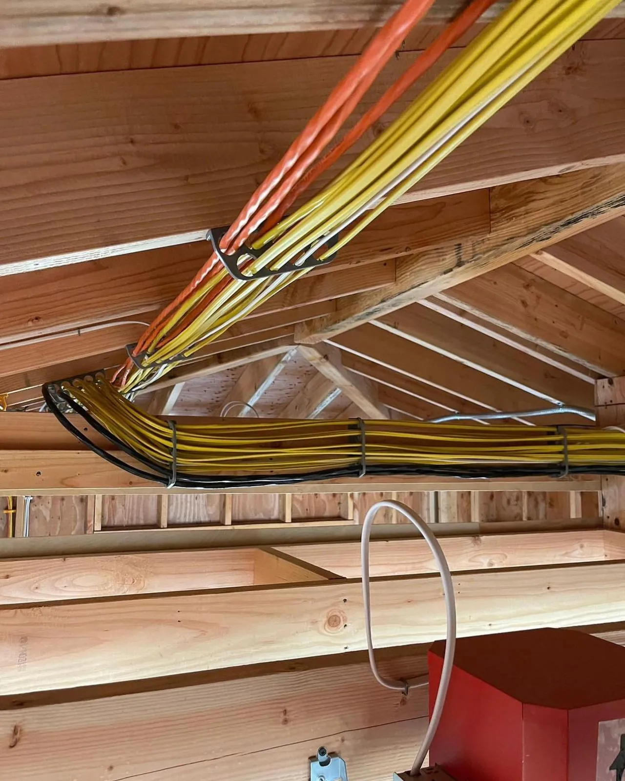 Attic peak with organized cable bundles. Clean work by Martinez Electric Corp