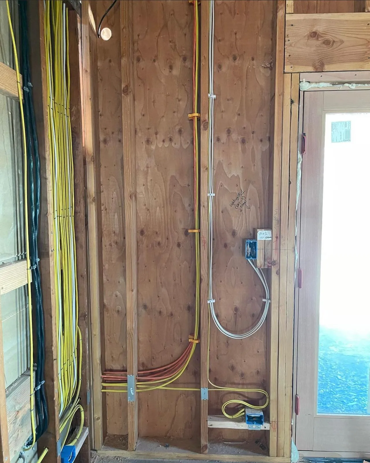 Structured wiring along stairwell wall mid-installation. Martinez Electric Corp
