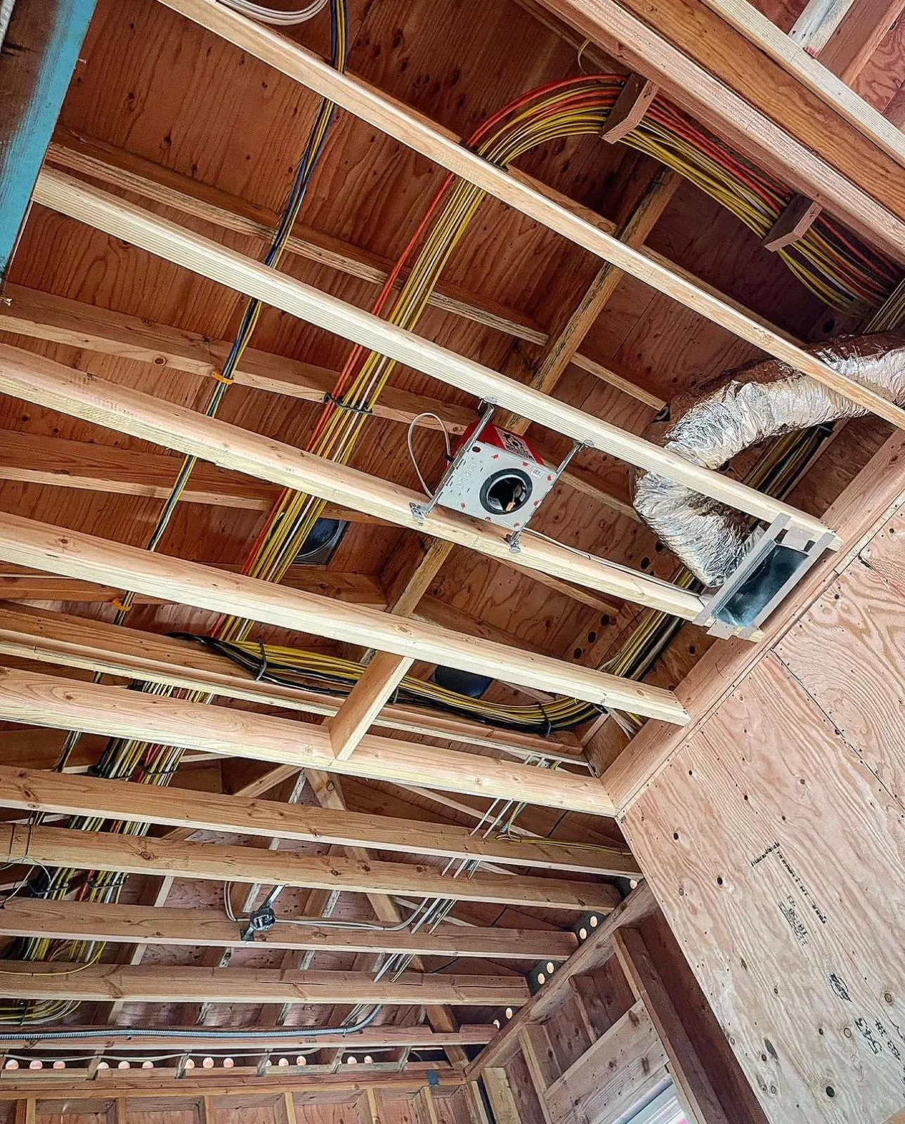 Rough-in wiring through framed ceiling during new construction. Martinez Electric Corp